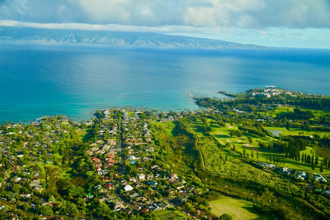 Aerial view of the Napili and Kapalua coastline on West Maui, with reef visible through turquoise water and Molokai across the channel